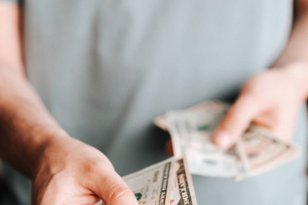 Free Crop man paying with American dollars Stock Photo
