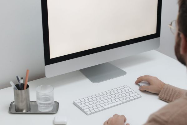 Free Crop man working on computer in workplace Stock Photo